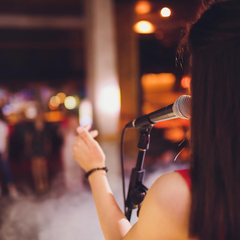 Woman singing at musical show.